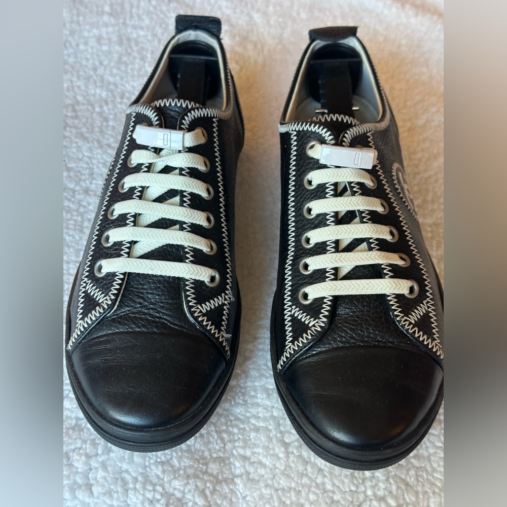 CHANEL Black Leather Sneakers with White Stitching and Laces